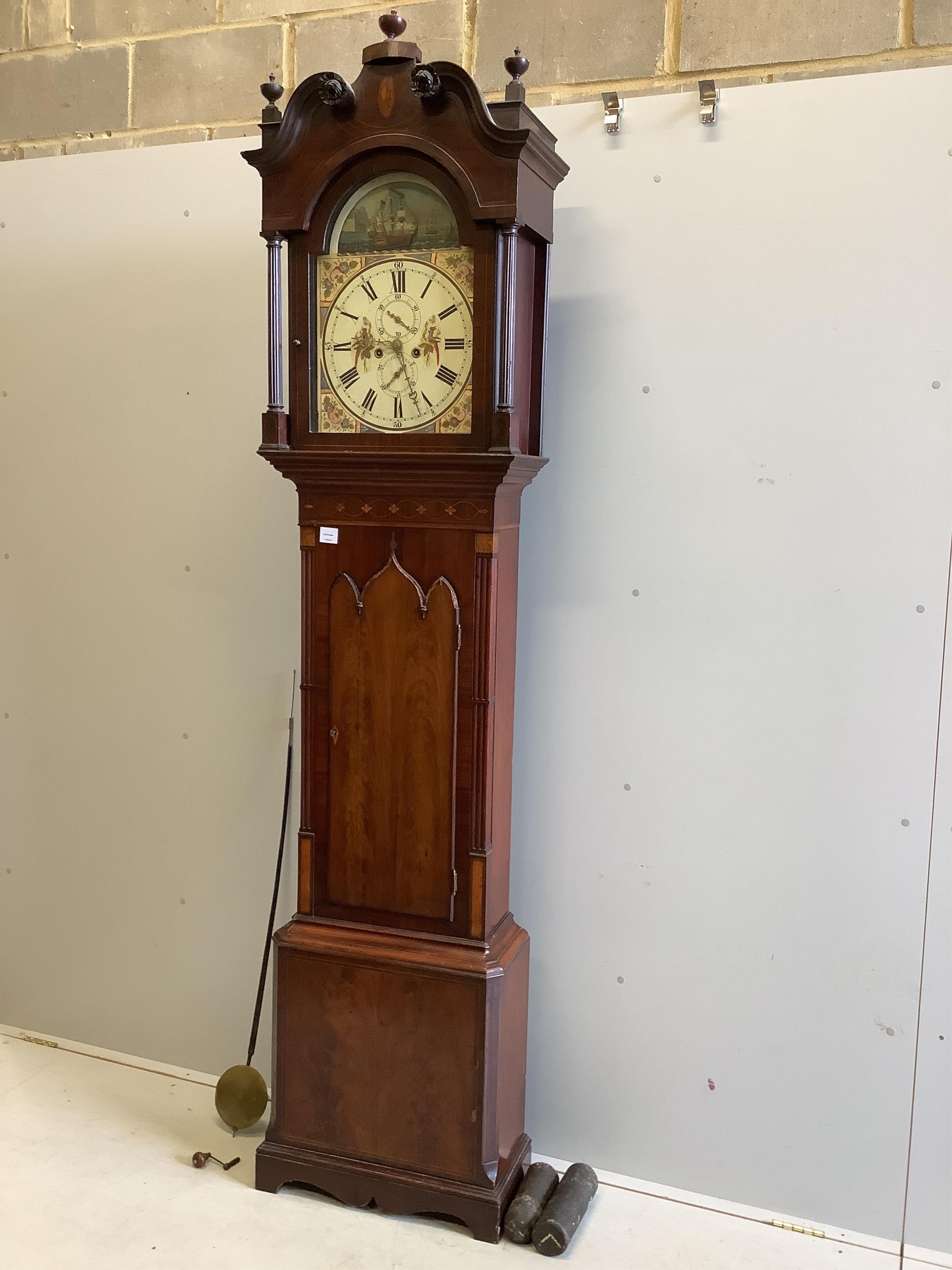 An early 19th century inlaid mahogany North Country eight day longcase clock, the arched painted dial with a ‘‘rocking’’ ship, height 240cm. Condition - fair, door lacks a section of moulding